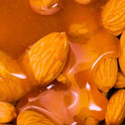 Caramel flowing into almonds